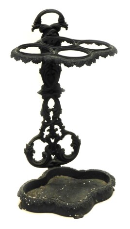 A cast iron four division umbrella stand in Victorian style, decorated with leaves with trefoil base, 67cm high, 40cm wide.