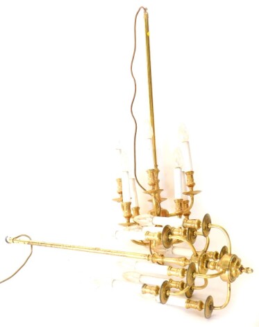 A pair of brass effect two tier chandeliers, each with six simulated candle fittings, 92cm high x 34cm wide.