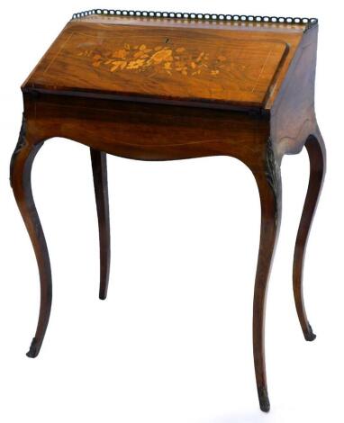 A 19thC rosewood and marquetry bonheur du jour, with a raised brass gallery, the fall enclosing a fitted interior with leather inset and a sliding base, on cabriole legs with gilt metal mounts, 66cm wide.