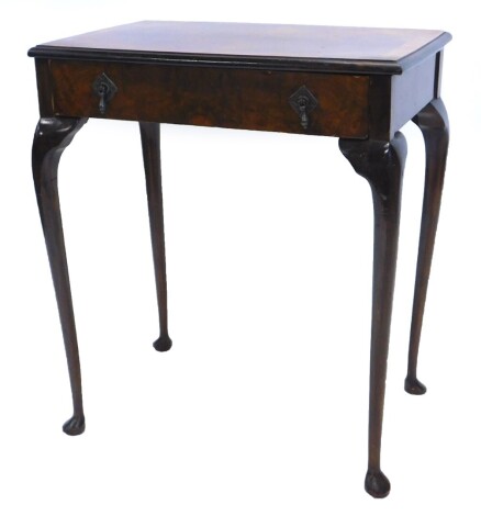 A walnut side table, with a rectangular cross quarter veneered and cross banded top with a moulded edge, above a frieze drawer with teardrop shaped handles on slender cabriole legs with pad feet, 61cm wide.