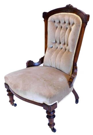 A late Victorian walnut nursing chair, with a padded button back, a padded seat on turned legs, with castors.