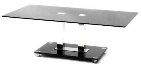 A modern smoked glass and chrome plated coffee table, with a rectangular top on twin square section supports with an under tier, 43cm high, the top 65cm x 100cm.