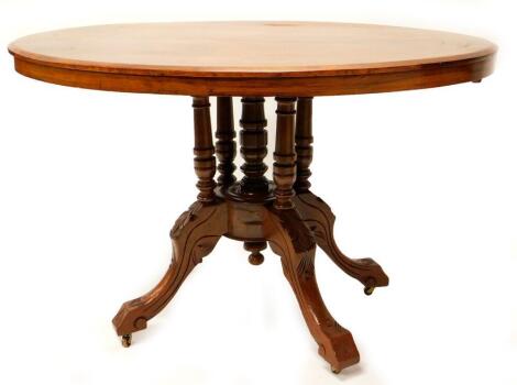 A Victorian walnut and marquetry oval breakfast table, the top with a moulded edge, on five turned supports with carved splayed legs, with castors, 72cm high, the top 84cm x 118cm.