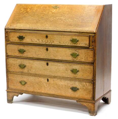 An early 19thC oak bureau, with a fall enclosing a mahogany fitted interior, with leatherette inset, above four graduated drawers, with later brass handles on bracket feet, 107cm wide.