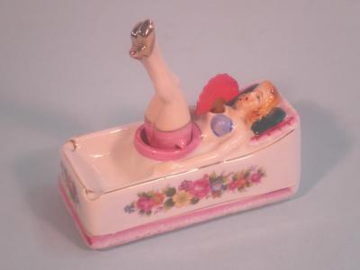 A continental porcelain and novelty ashtray in the form of a 'Glamour Lady'