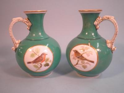 A pair of mid 19thC Staffordshire porcelain jugs