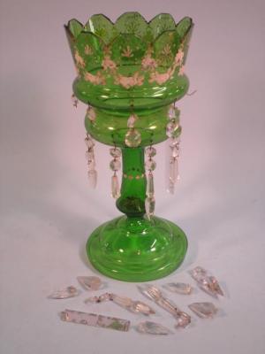 A Victorian green glass lustre decorated in coloured enamels with flowers