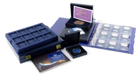 A collection of various commemorative coins and medallions, to include a zinc alloy longest reigning Monarch Queen Elizabeth antique medal with antique gold finish, edition number 995, in fitted case, various commemorative five pound coins, and a Sapphire