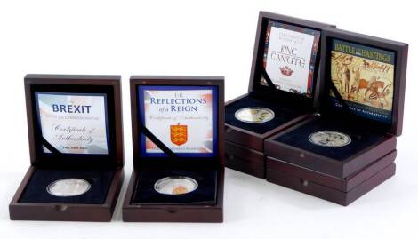 A collection of silver five pound proof and other commemorative coins, relating to the Battle of Hastings, King Canute, the Battle of Waterloo, Elizabeth II reflections on her reign, Brexit, and HRH Prince George of Cambridge, all boxed with certificates.