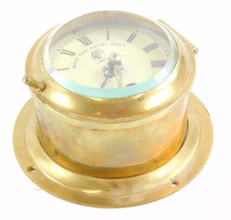 A brass cased ship's clock or timepiece, stamp to the dial Made For Royal Navy, London, 13cm diameter.