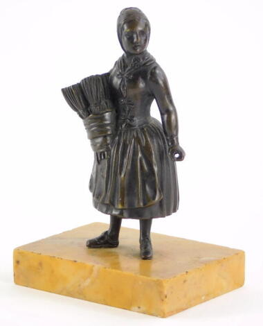 A 19thC continental bronze match holder, modelled in the form of a lady, on a yellow marble base, 12cm high.