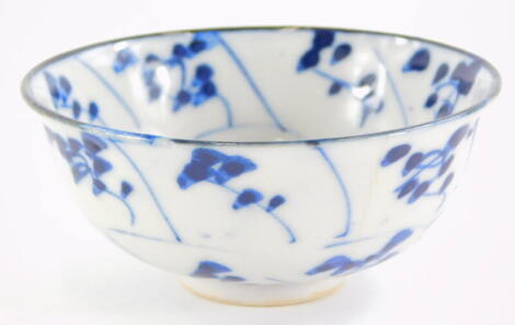 An oriental porcelain tea bowl, decorated with leaves, etc., in blue, possibly Japanese, 8cm diameter.