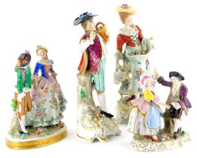 A collection of porcelain figurines, to include a gentleman and lady with flowers, and two dancing figure groups, the largest 24cm high.