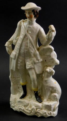 A 19thC Staffordshire flat back figure, of a Huntsman with his Hound, 33cm high.