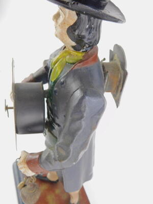 A Dutch painted spelter figural mantel clock, modelled in the form of a gentleman wearing a top hat, and with a cane the arched dial decorated with windmills etc., on a rectangular base, 42cm high. - 2