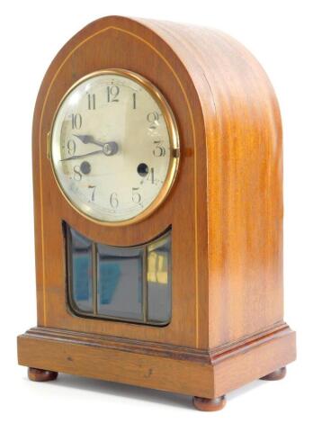 An Edwardian mahogany and boxwood strung lancet shaped mantel clock, with silver dial and leaded glass panel, 31cm high.