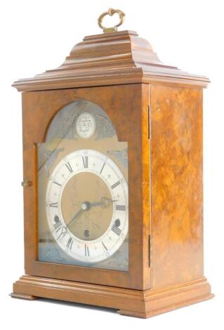 An Elliott mantel clock in walnut and burr walnut case, the arch dial stamped Tempus Fugit, with Westminster chime, on bracket feet, 40cm high.