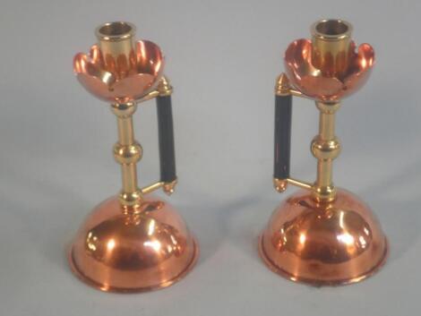 A pair of late 19thC Arts & Craft style copper and brass candlesticks