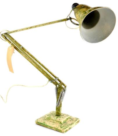 A cream Anglepoise lamp, with green camouflage decoration.