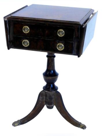 A walnut occasional table, the rectangular top with two drop leaves and a moulded edge above two drawers, on a turned column and splayed legs with brass paw feet, 63cm high, 68cm wide. (AF)