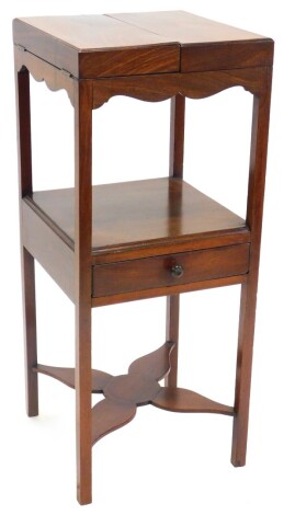 A George III mahogany enclosed washstand, the double hinged top enclosing recesses for two beakers and a bowl, on square section supports with drawer and X shaped support for a wash jug or chamber pot, 88cm high, 38cm wide.