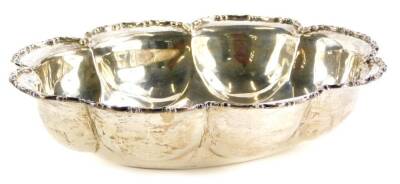 A George V silver bowl, with a shaped edge, cast with scrolls, Chester 1912, makers stamp indistinct, 6½oz, 20cm wide.