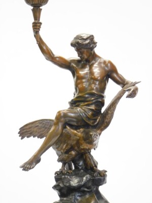 After Emile Louis Picault (1833-1915). A spelter figure of a gentleman carrying a torch, seated on an eagle, inscribed Letud Affranchit La Pensee, on a marble plinth, 104cm high overall, and an associated modern simulated bronze pedestal 101cm high. Buye - 2