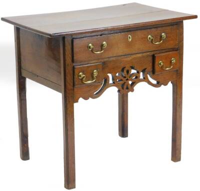 A late 18th/early 19thC oak lowboy, the rectangular planked top above a long drawer and two drawers, with a pierced and shaped apron on a square section legs, 71cm high, 76cm wide, 48cm deep.