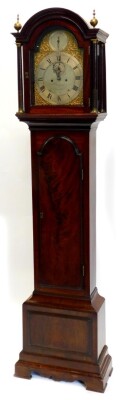 Budgen Croydon. A George III longcase clock, the arched dial with pierced rococco scroll spandrels, strike silence subsidiary and silvered chapter ring with Roman numerals, eight day, four pillar movement in a mahogany case, with moulded arched top, turne