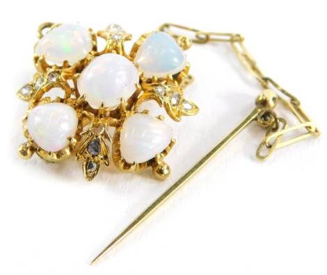 A Victorian opal and diamond brooch, with central over cut opal in claw setting, surrounded by four triangle cut opals and design of three tiny diamonds, on a yellow metal pin back, with safety chain and end pin, yellow metal unmarked, 2cm wide, 4.2g all 