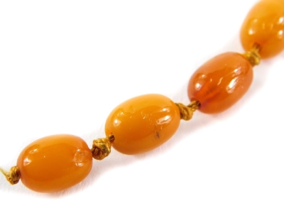 A butterscotch amber necklace, with various graduated beads, approximately 80cm long overall. - 2