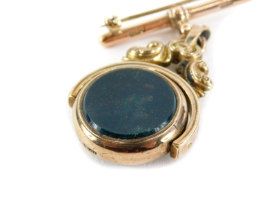 A late 19thC swivel agate fob, the earlier fob converted to a brooch with green and red agate, on a yellow metal scroll rococo setting, stamped 10ct, on a later 9ct gold pin bar, 5cm high x 4cm wide, 18.2g all in. - 2