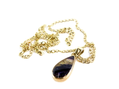 A 9ct gold Blue John set pendant and chain, the teardrop shape Blue John pendant in a rub over 9ct gold setting, 2.5cm high, on a 9ct gold curb link chain stamped Italy, the pendant with maker's stamp GWS, 5.4g all in.