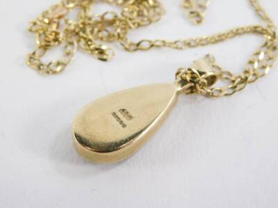 A 9ct gold Blue John set pendant and chain, the teardrop shape Blue John pendant in a rub over 9ct gold setting, 2.5cm high, on a 9ct gold curb link chain stamped Italy, the pendant with maker's stamp GWS, 5.4g all in. - 2