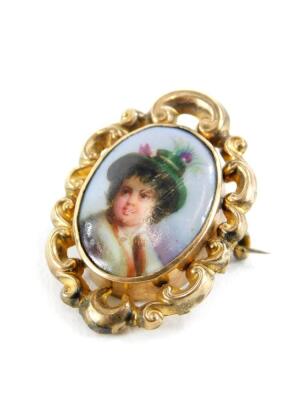 A late 19thC portrait memorial brooch, the oval portrait depicting a boy in feathered hat, in rococo scroll gilt metal border, on a memorial panel back, 3cm x 2cm.