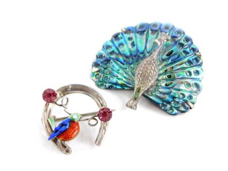 Two animal brooches, comprising a mother of pearl and white metal peacock brooch, stamped sil 925, 4.5cm wide, together with a silver and enamel bird brooch set with two pink paste stones, in a horseshoe shape stamped sterling silver, maker's stamp W.BS, 