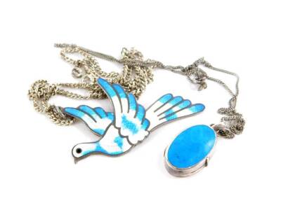 Two necklaces, to include a dove enamel brooch, white metal stamped sterling on a silver curb link chain, together with a silver and blue agate set oval locket pendant, on fine link chain, 22.7g all in. (2)