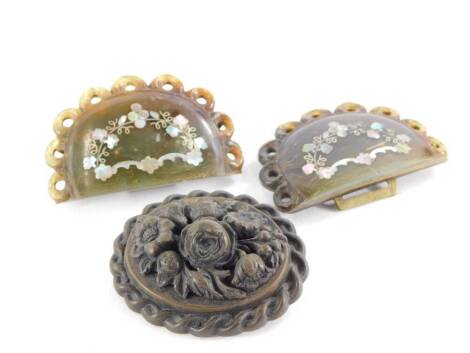 A carved wooden Victorian memorial brooch, with raised floral decoration, 5.5cm wide, together with a 19thC turquoise and mother of pearl inlay belt buckle, 6.5cm wide. (2)