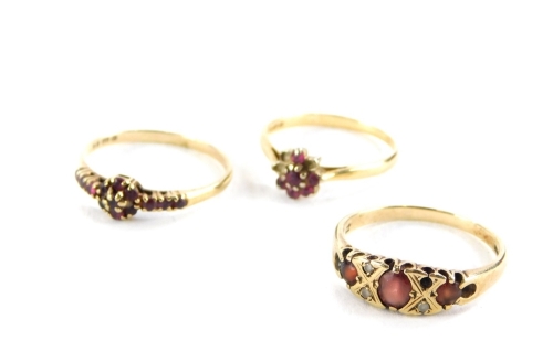 Three gold and red stone dress rings, two set in 9ct gold, 4.4g all in, and one set in 18ct gold, 1.9g all in.