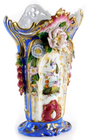 A Paris porcelain vase, of tapering form with a pierced shaped edge, decorated with rococo scrolls above flowering encrusted bands, above a panel of peacocks, flowers, etc., on an oval base, unmarked, 31cm high.