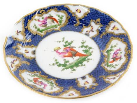 A Samson French porcelain plate, decorated with Asiatic pheasants, within rococo gilt raised cartouches, on a blue scale ground, pseudo Chinese mark to underside, (AF), 22cm diameter.