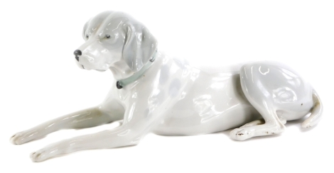 A continental porcelain model of a hound, with mottled decoration, 27cm long.