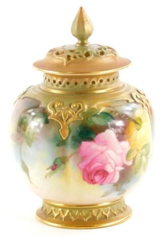 A Royal Worcester porcelain pot pourri jar and cover, the pierced lid with a shaped finial, the base painted with roses, on a blush ivory ground with Moorish arches, printed marks in green and pattern number 278, 14cm high.