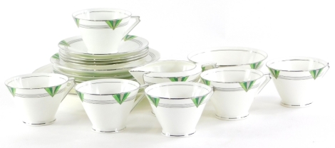 A Coalport porcelain Art Deco part tea service, each piece decorated in green and silver with triangular motifs, the handles of triangular form, etc., comprising six cups, milk jug, sugar bowl, four saucers, five side plates and a cake plate.