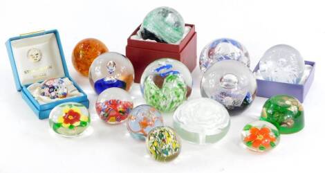 A collection of coloured glass paperweights, to include a Selkirk example, Strathern, etc.