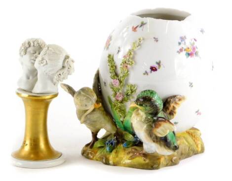 A German porcelain vase, decorated with chicks, flowers, etc., cross swords mark to underside, (AF), and a Capodimonte bust of two young people kissing, signed to the gilt pedestal. (2)