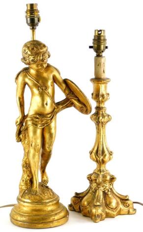 A gilt plaster table lamp base, decorated in the form of a young cherub holding a shield with quiver attached, 50cm high, and another gilt table lamp. (2)