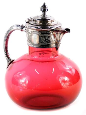 A Victorian cranberry tinted glass claret jug, with engraved silver plated mounts, 20cm high.