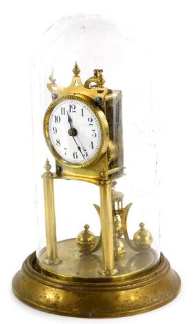 A Keininger and Obergfell brass Anniversary type clock, with a white enamel dial and a glass dome, 31cm high overall.