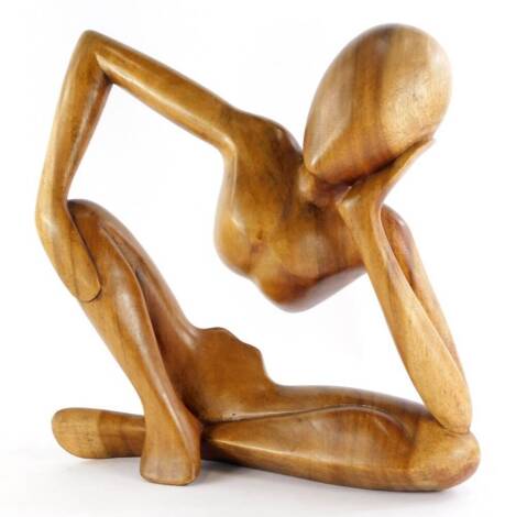 A hardwood sculpture, of a seated figure, 41cm high, 40cm wide.